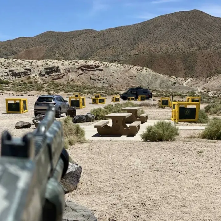 Players competing in a laser tag match on a desert-themed battlefield